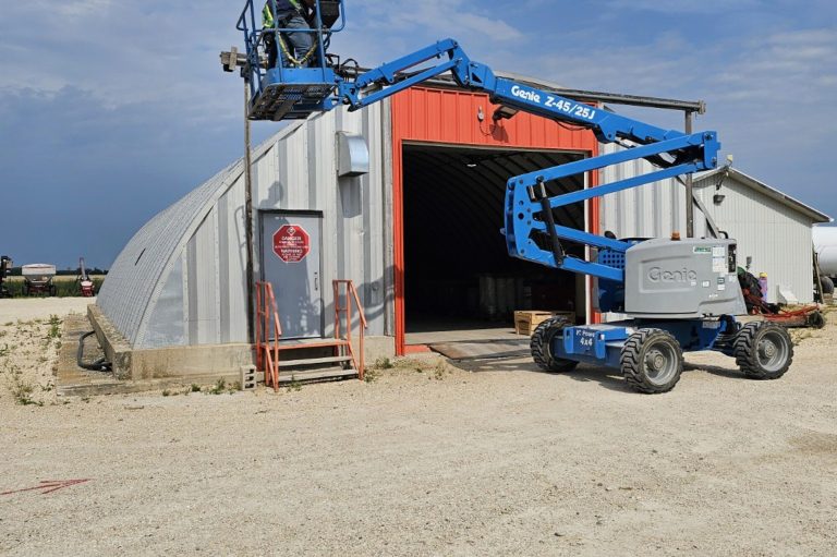 Boom lift parked outside a shop in Manitoba, used for aerial lifts train the trainer courses covering scissor and boom lifts