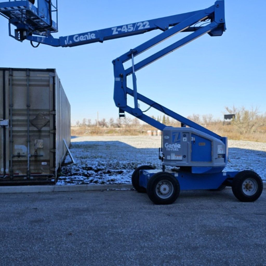 Boom lift with the boom raised in a Manitoba yard, used for boom lift train the trainer courses