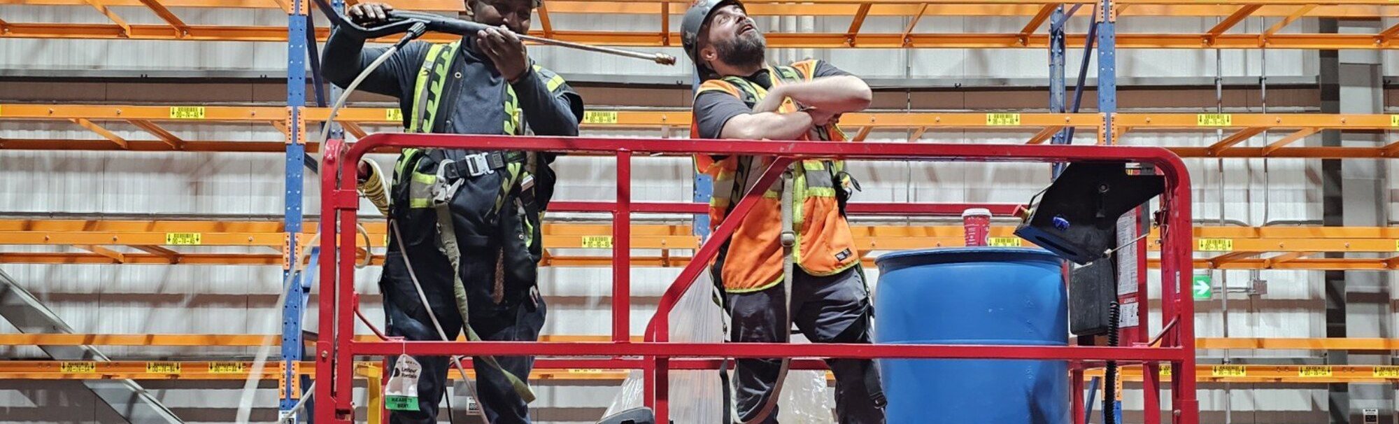 Two workers together on a raised scissor lift platform during a scissor lift train the trainer course in Winnipeg